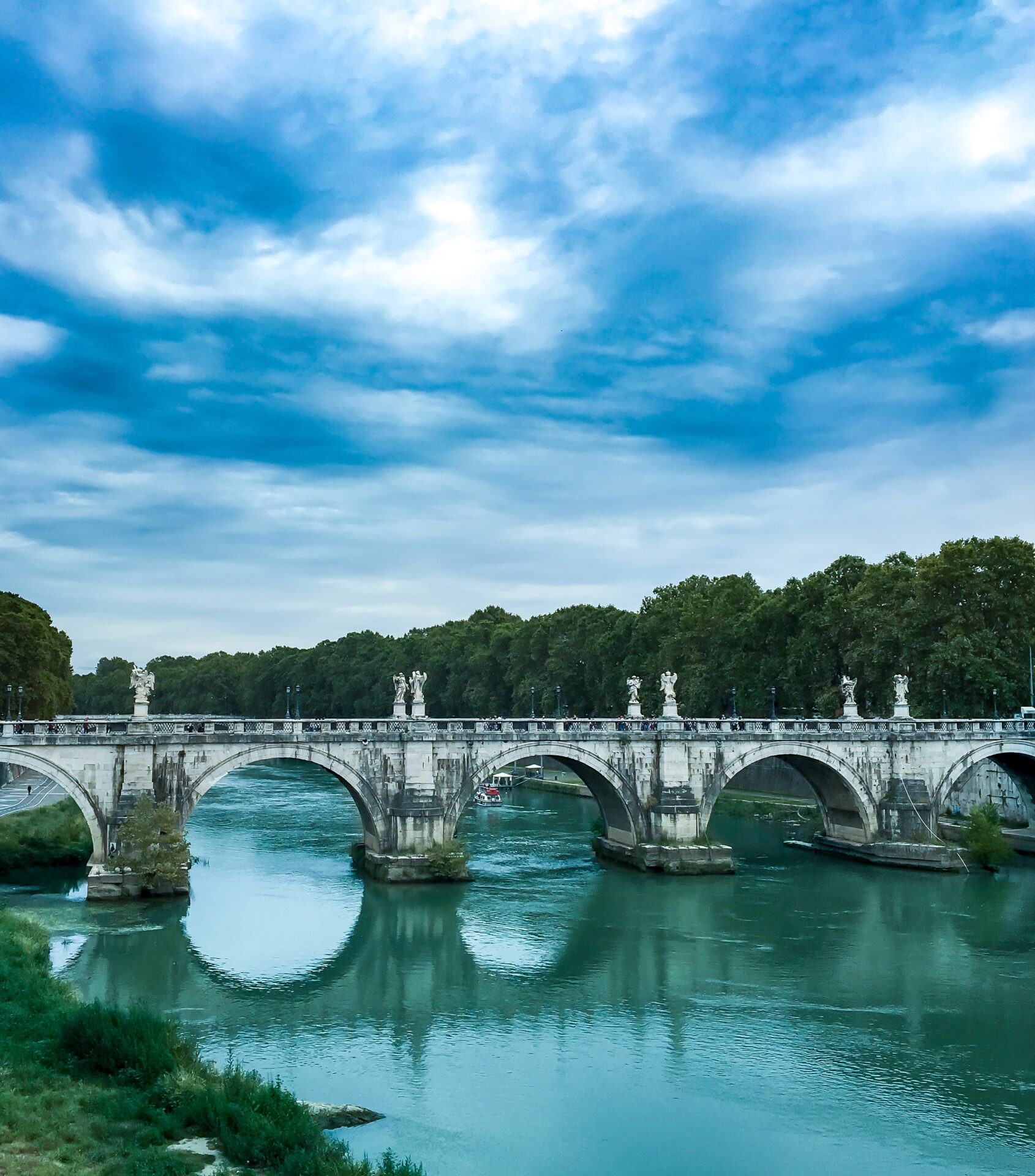 Exterior photo of bridge oPonte Sant' Angelo and Tiber river in Rome, Italy