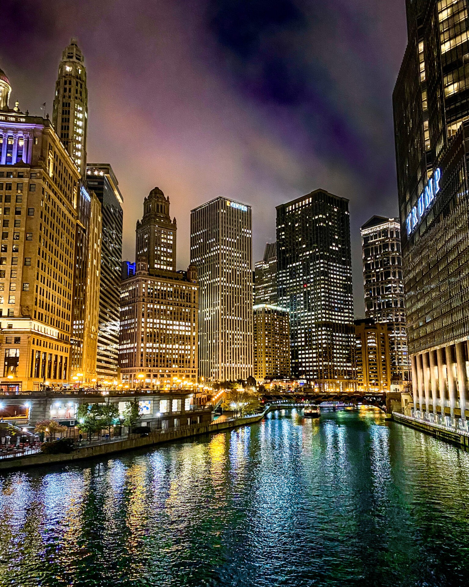 Nighttime city scape with lit skyscrapers on the river in Chicago Illinois