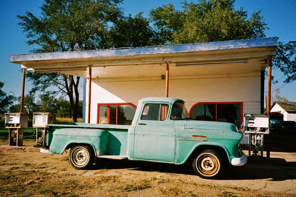 Vintage pick up truck infront of vintage gas station