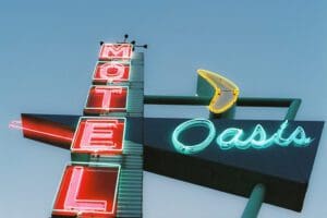 Dusk skies, looking up at the Historic Route neon sign for Oasis Motel in Tulsa, OK