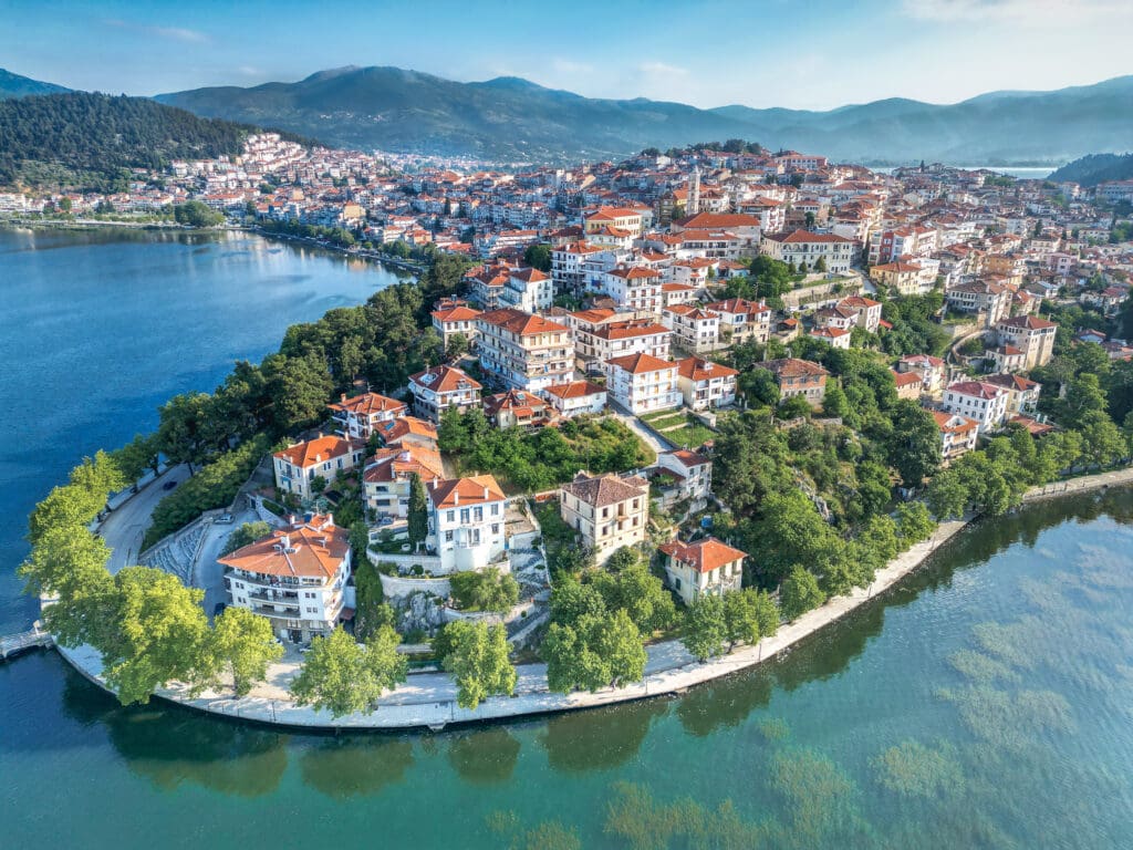 Aerial photo of the town of Kastoria with manor houses on the hills that protrude into the crystal clear lake