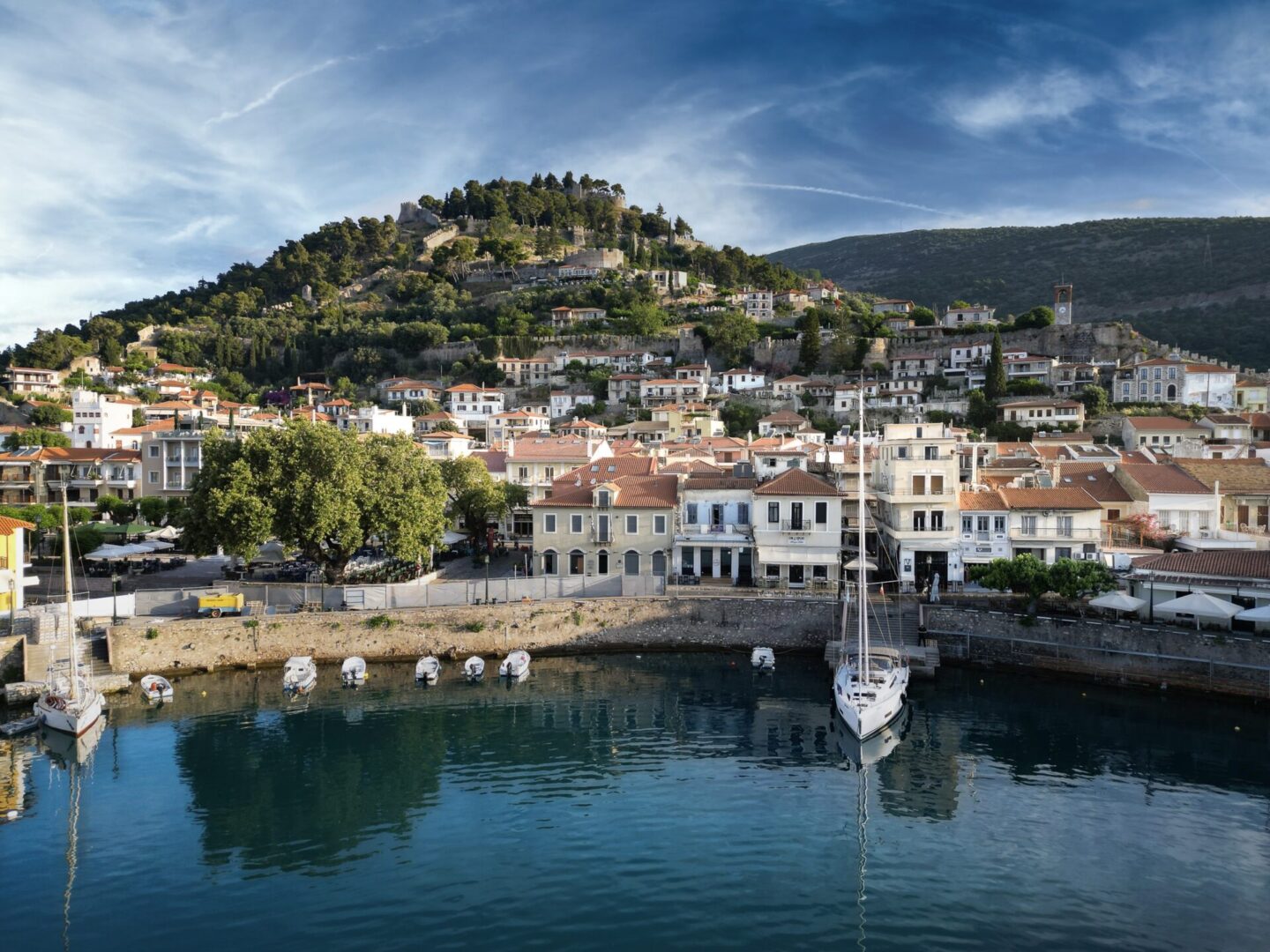 A boat is in the water near some buildings.