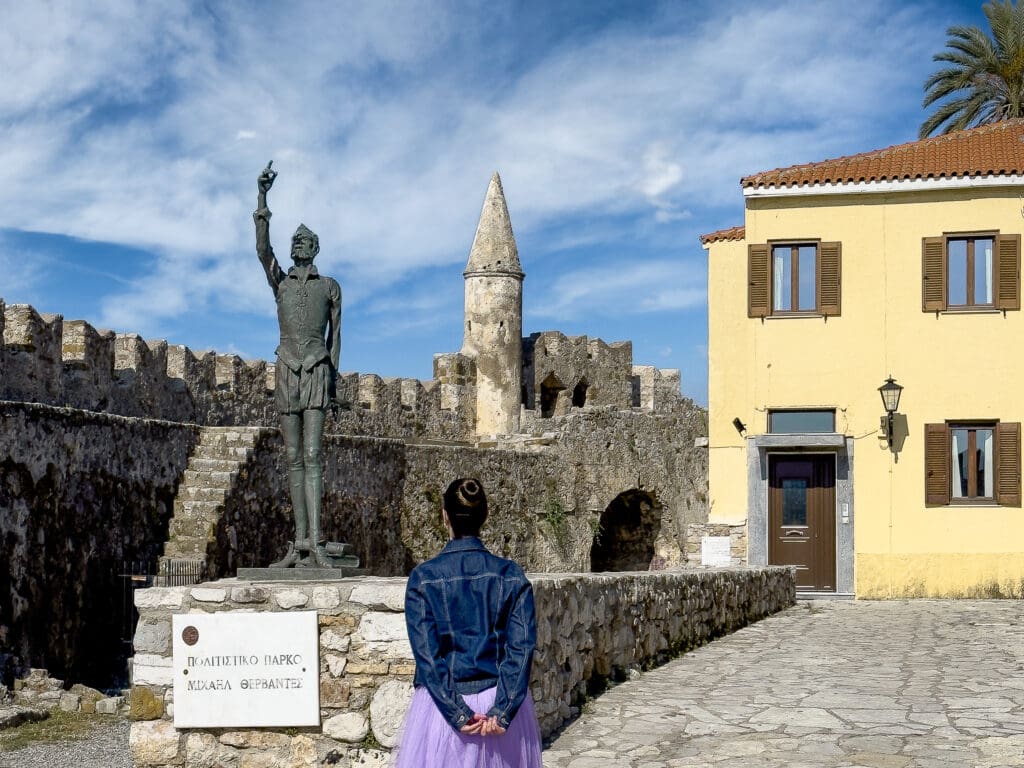 A woman standing in front of a statue.