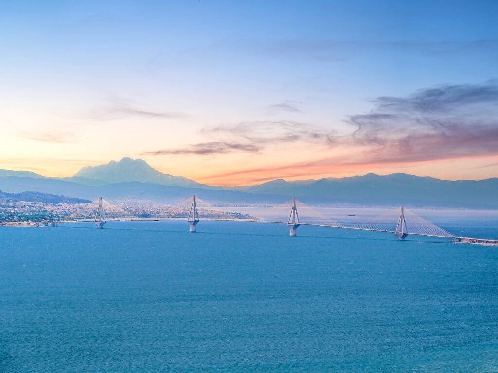 A view of the ocean with mountains in the background.
