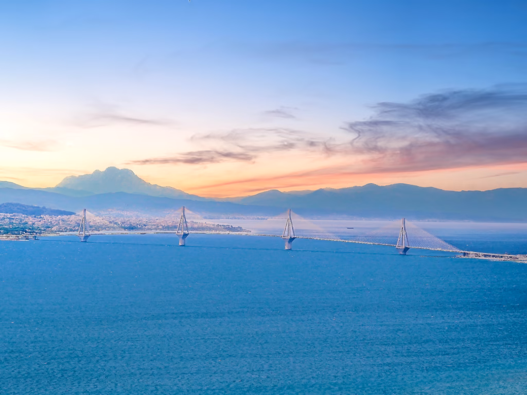 A view of the ocean with mountains in the background.