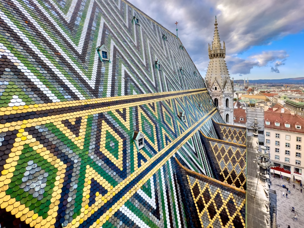 Roof line and tower of a 12th century Gothic cathedral; St Stephen's Cathedral at Stephansplatz, taken from the North Tower offering panoramic vistas of Vienna.