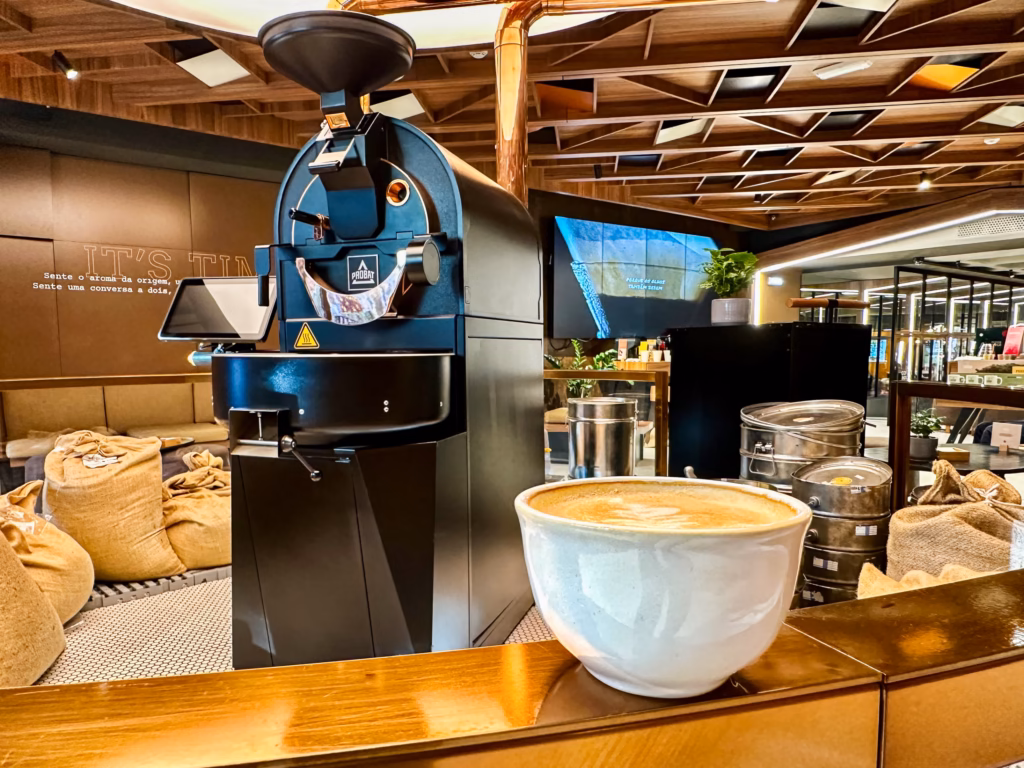 A coffee machine and bowl of food on the counter.