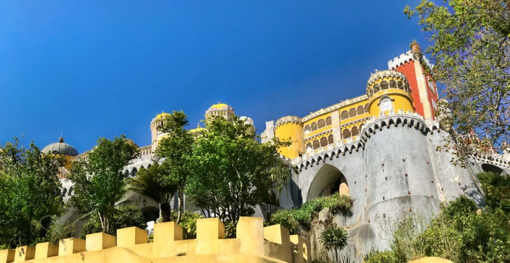 The facade of the colorful and whimsical Pena Palace in Sintra, a must visit destination on any 3 day visit in Lisbon Portugal