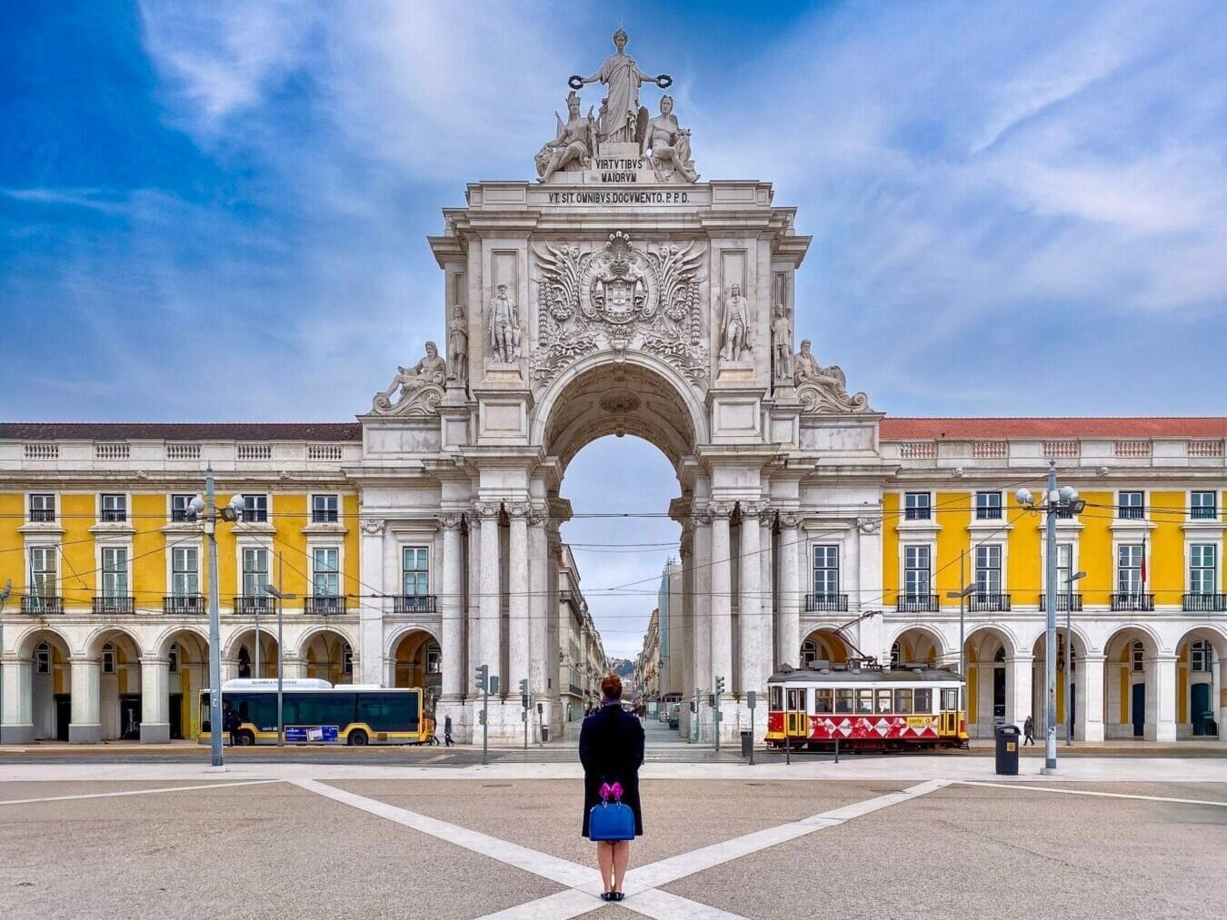 Lisbon, Portugal A person standing in front of an arch.