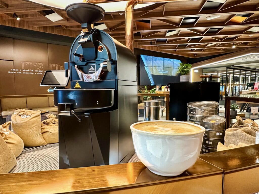 Interior decor including the coffee bean roasting machine inside the Delta Coffee House Experience, enjoying a third wave cappuccino 