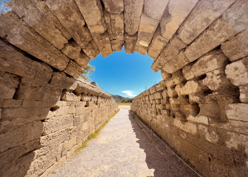 Stone arch marking the entrance to the stadium in ancient Olympia. Photo by Paul Kostadimas © SpotlightSojourns.com