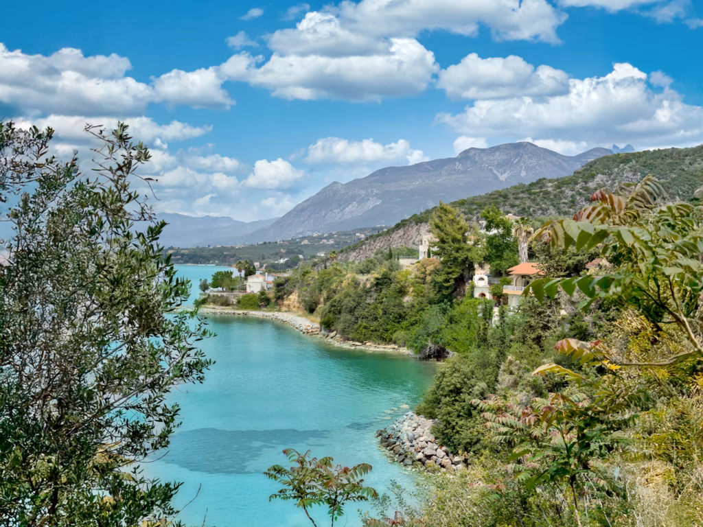 Secluded wooded bay with turqoise sea in sprintime Greece. Plan your trip to Greece in shoulder season
