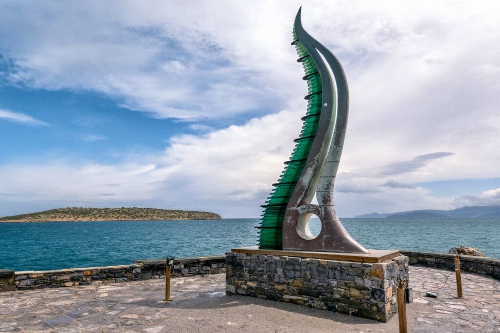 Sculpture in a horn form of the Horn of Amalthea beyond the port of Agios Nikolaos