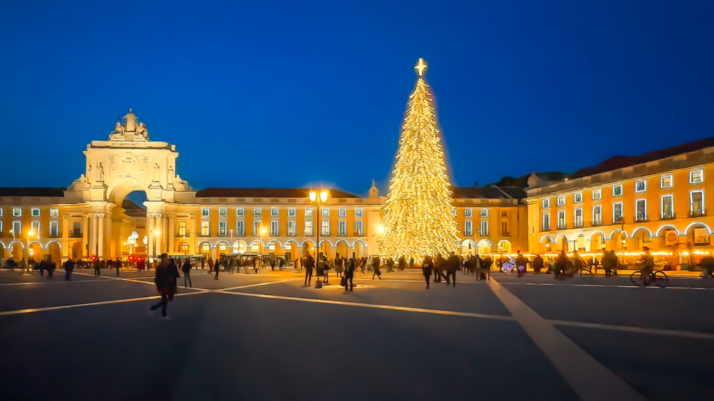 A large christmas tree in the middle of a city.