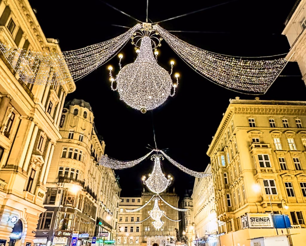 A street with many lights and chandeliers hanging from the ceiling.