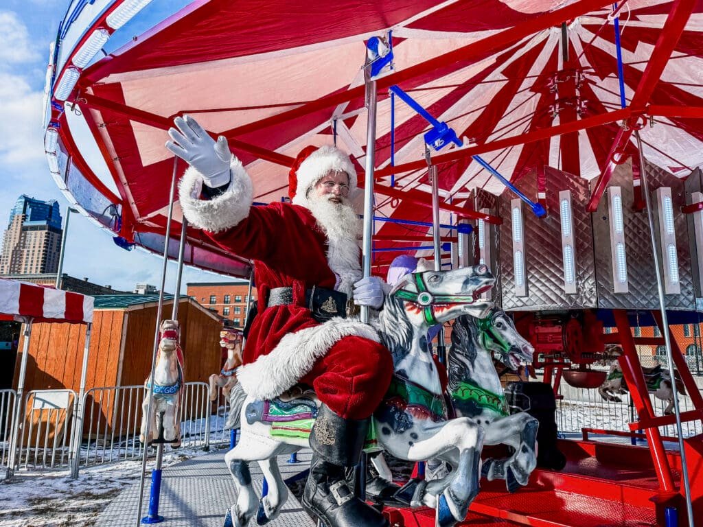 Santa Claus riding on a carousels at the Christmas Market