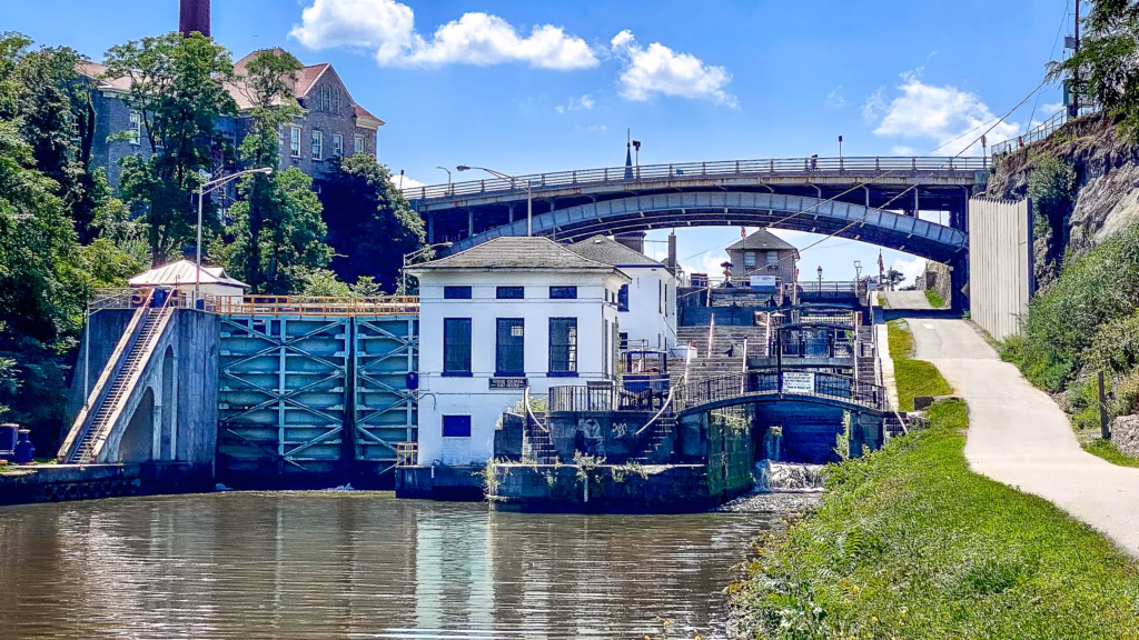 A bridge over water with buildings on top of it.