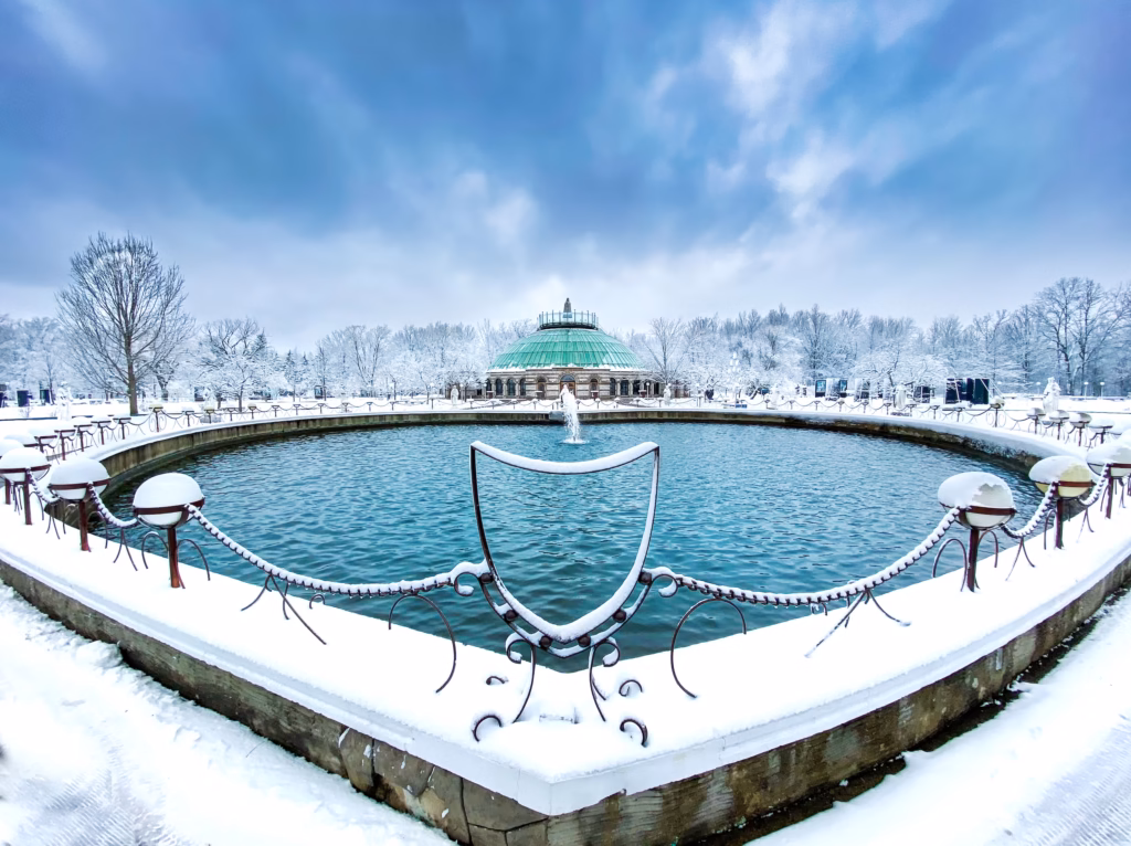 A large pool of water with snow on the ground. Our Lady of Fatima basilica is one of new york's most wonderful sites off the beaten path