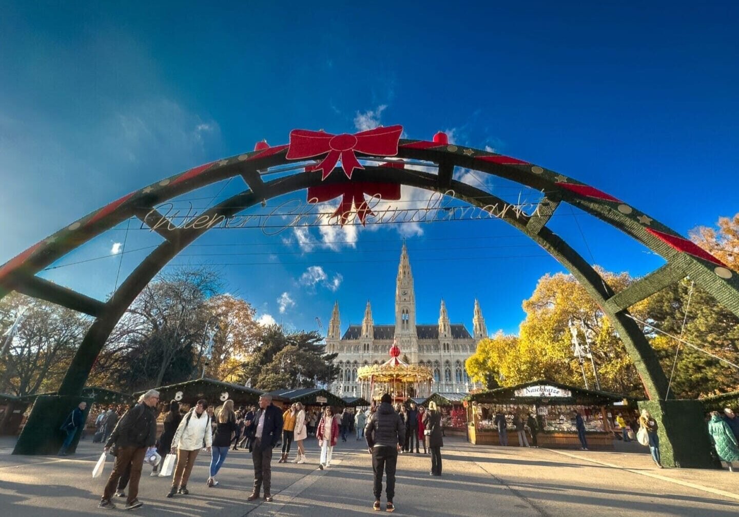 Vienna, Austria Exterior photo of a sunny winter's day infront of the decorated gates to the Rathausplatz Christkindlmarkt (Christmas market) at the Rathausplatz square.